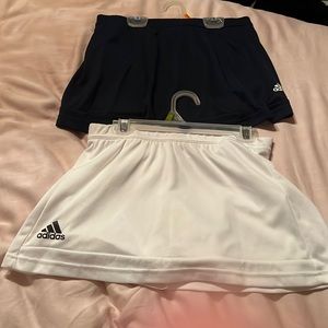 Navy and white adidas tennis skirts.